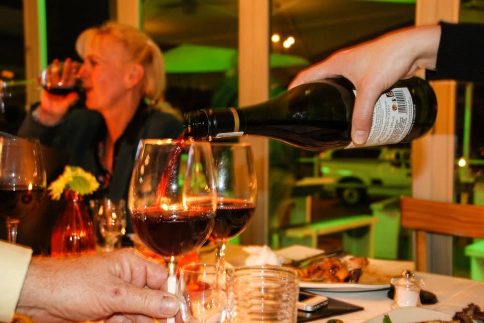 Red wine being poured for guests at Café Zest